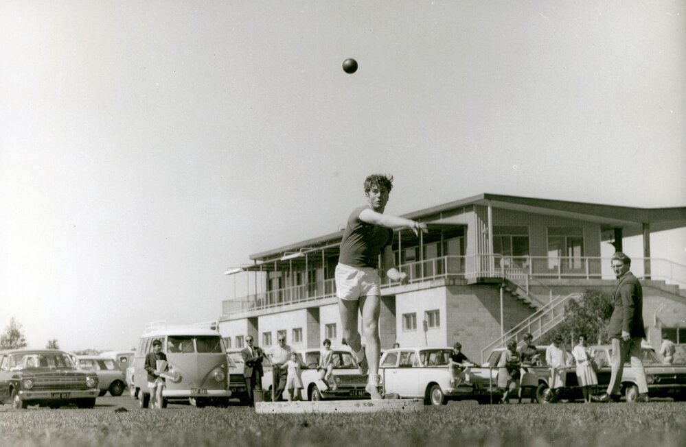 Boy throwing shot put, 1962