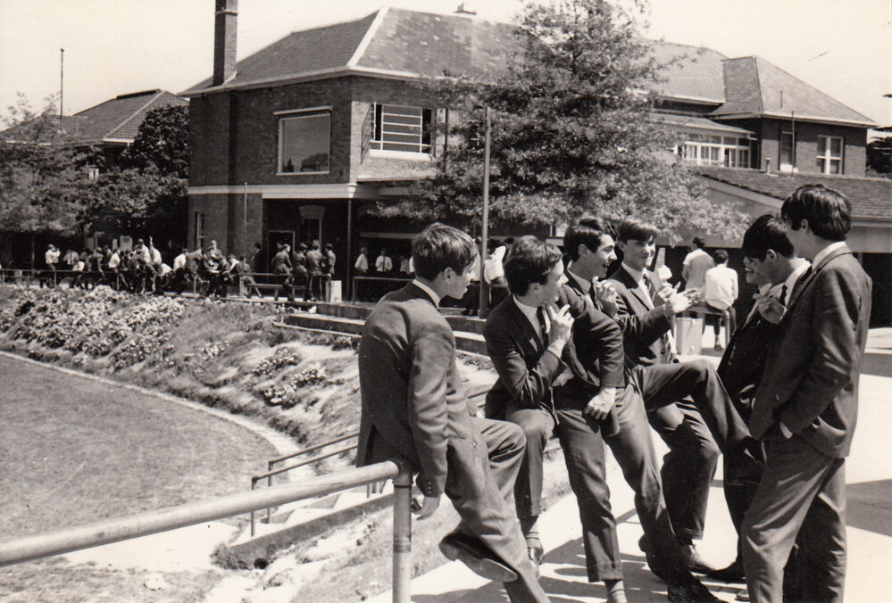 Students conversing on the bank of the Sandell Oval, 1967