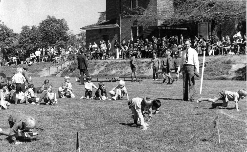 Don Brown observing Preparatory School sports on the Sandell Oval, 1970s