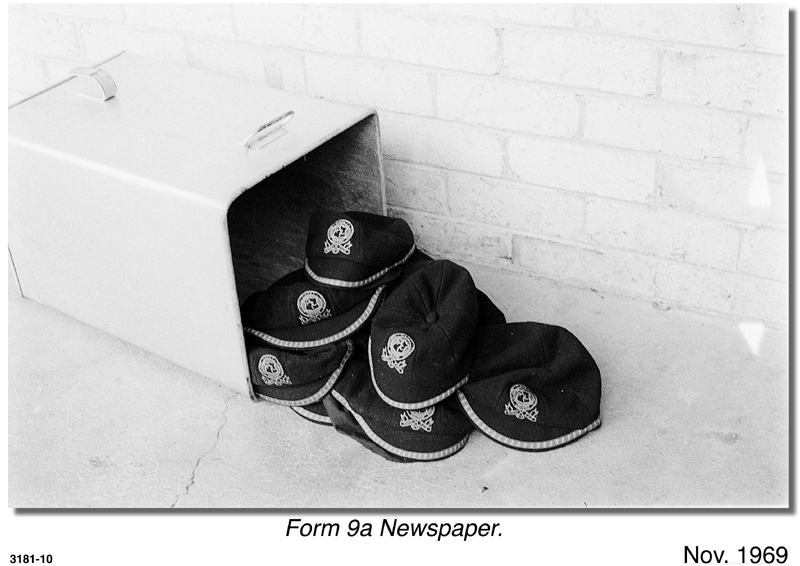 School caps next to rubbish bin, 1969