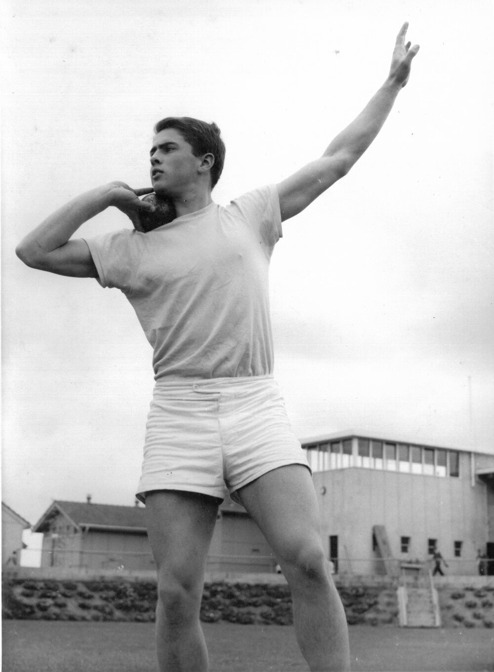 Unidentified male student with shot put, 1950s