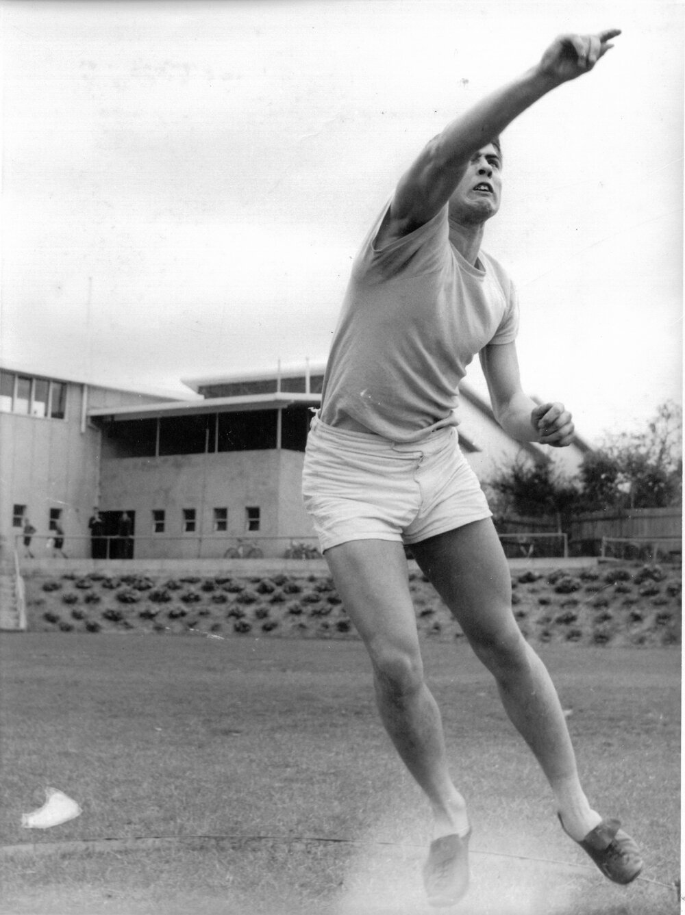 Unidentified male student with shot put, 1950s