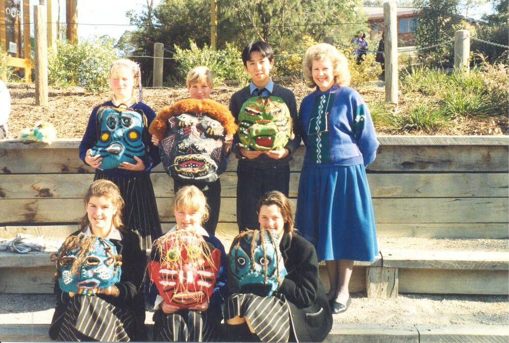 Wendy Weeks (Hirt) with students displaying papier-m&acirc;ch&eacute; masks, 1990s