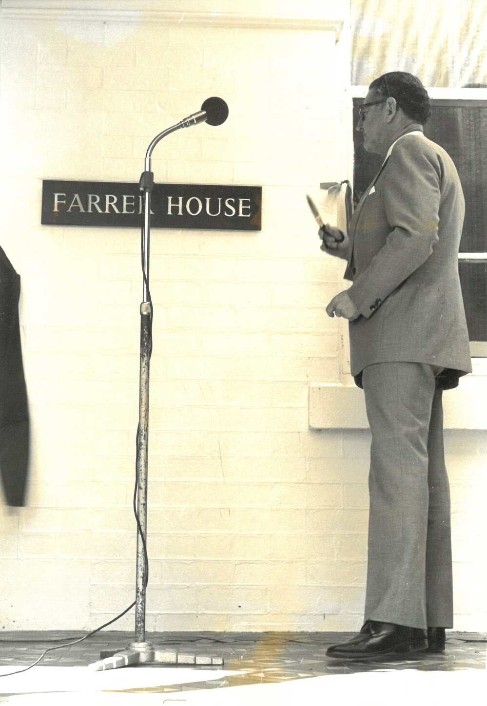 Dr Keith Farrer cuts the ribbon at opening of Farrer House, 1980