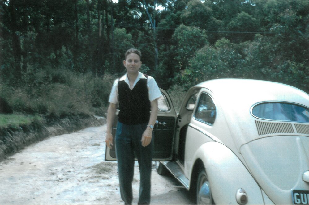 Reverend Alan Wright with his Volkswagen Beetle, 1960