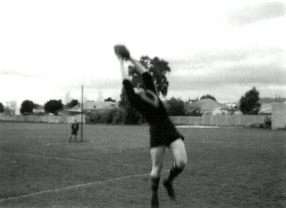 John Elliott taking a mark on Haslam Oval, 1958