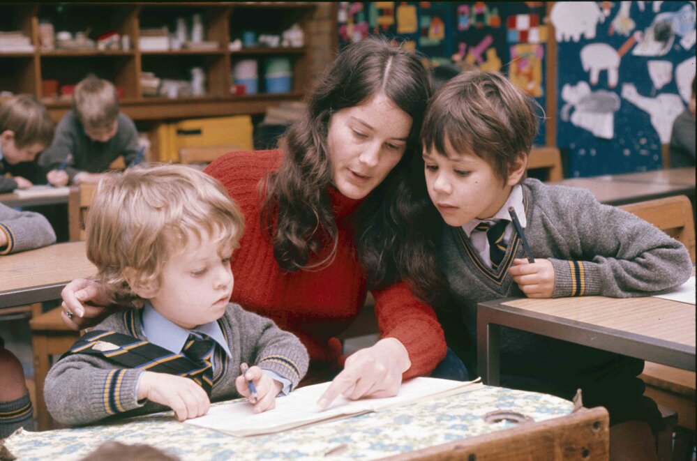 Female teacher with Preparatory School boys, 1974