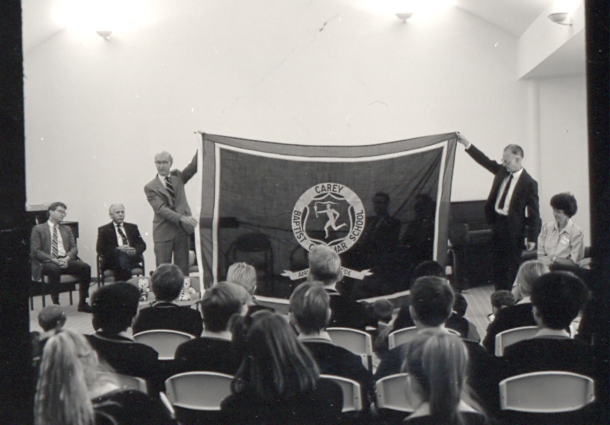 Raising the Carey flag at Donvale's first assembly, 1989