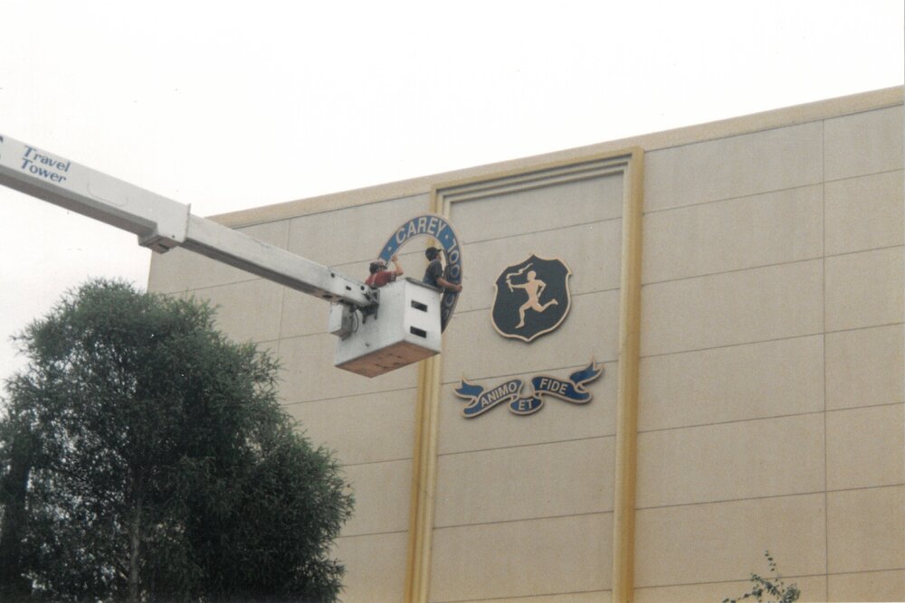 Placing the Carey logo and crest on the MGH, 1999