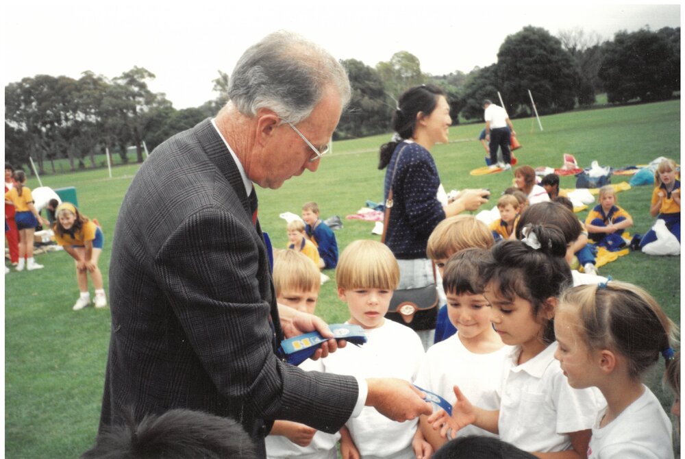 Don Brown presenting ribbons to winners at House Athletics, c. 1990