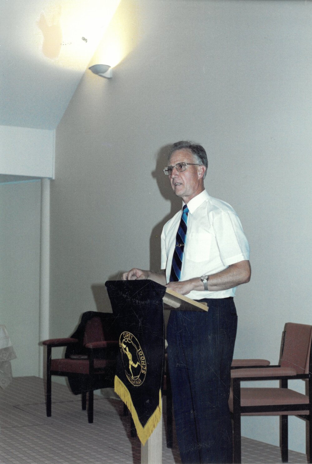 Don Brown addressing audice in the hall, 1990