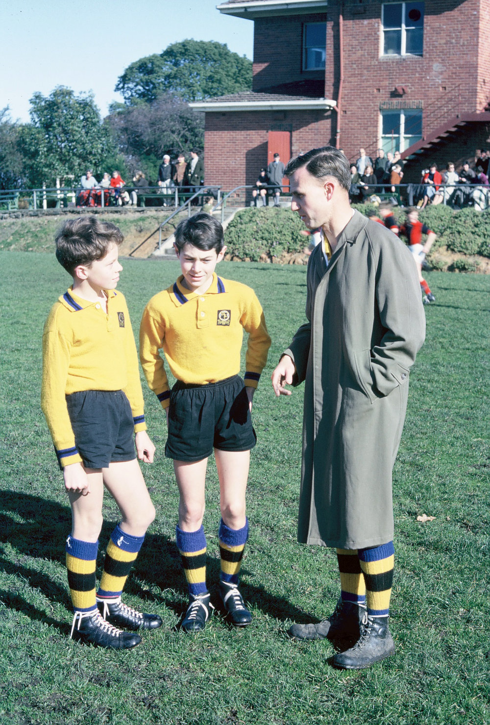 Captains confer with the coach, 1965 