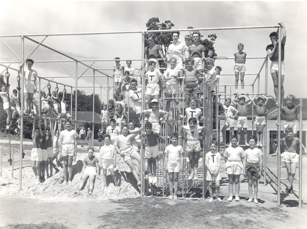 Junior school students on climbing frame, 1961