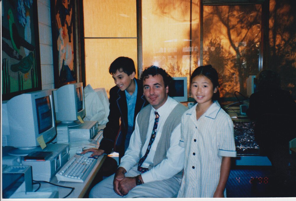John Bonnyman at computer with students, 1998