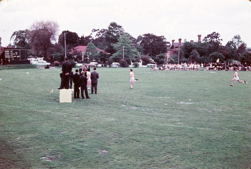 The judges prepare for the end 100 yard dash, 1959