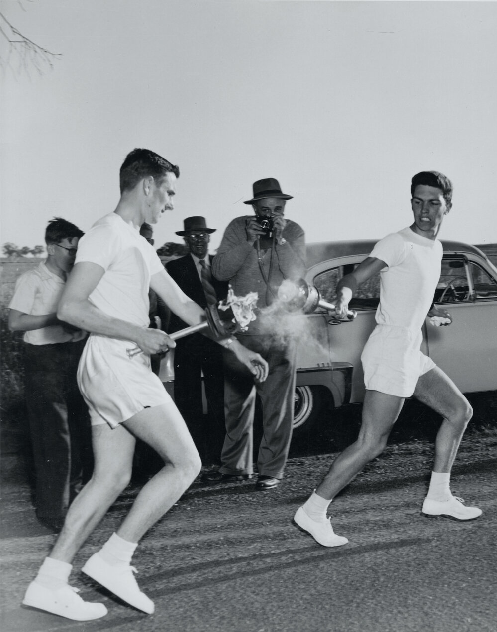 David Jenkin passing the torch to Peter Whitehead in the Melbourne Olympic Games torch relay, 1956
