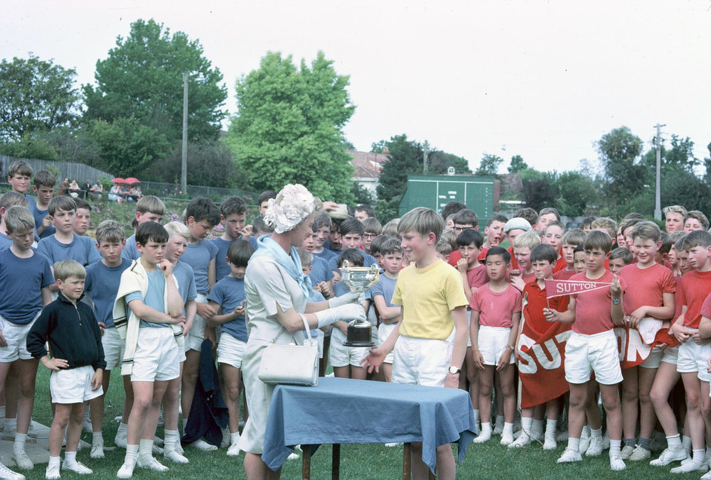 President of the Junior School Mothers' Association, Mrs. Beau Rostron, presents the cup to Moore House, 1965