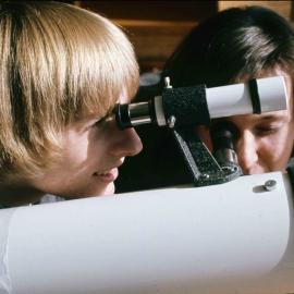 Senior student looking through a telescope, 1974