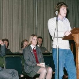 Senior student at lectern with Arthur Sandell looking on, 1974