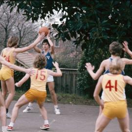 Students playing basketball, 1974