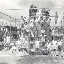 Junior school students on climbing frame, 1961
