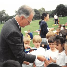 Don Brown presenting ribbons to winners at House Athletics, c. 1990