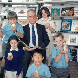 Don Brown in library with students holding chicks, circa 1991