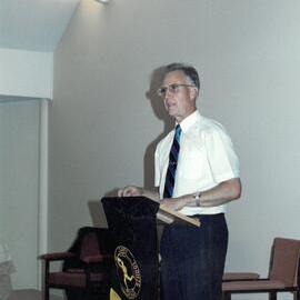 Don Brown addressing audice in the hall, 1990