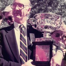 Mr Gerard Cramer holding the Fairbairn Challenge Cup, 1985