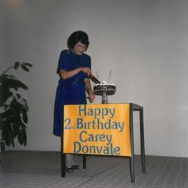 Shirley Allen cutting cake, 1991
