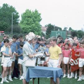President of the Junior School Mothers' Association, Mrs. Beau Rostron, presents the cup to Moore House, 1965