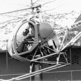 Helicopter landing on Sandell oval, 1973