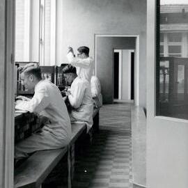 Students performing science experiment, 1960s