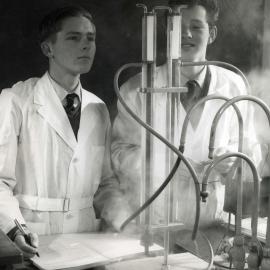 Students performing science experiment, 1960s