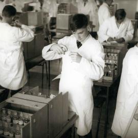 Students performing science experiment, 1961