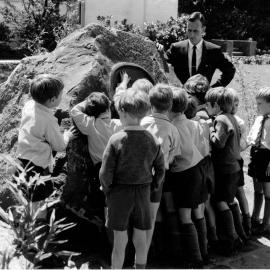 Don Brown showing students the William Carey bronze sculpture, 1980s