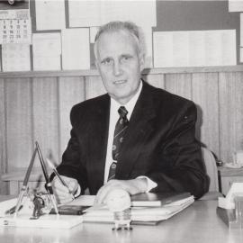Don Brown at desk, 1970s
