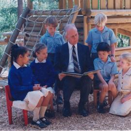 Don Brown reading to Year 2 students in playground, circa 1990