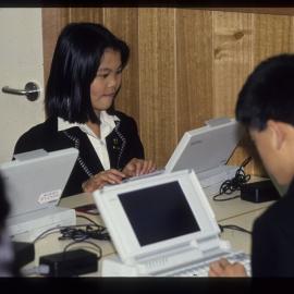 Students using laptop computers, 1990s