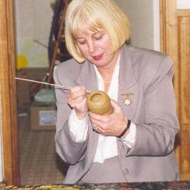 Helen Telford decorating pottery in the art room, 1990s