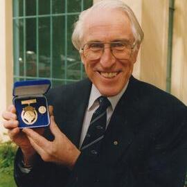 Professor Graeme Clark AM displaying his Carey Medal, 1997