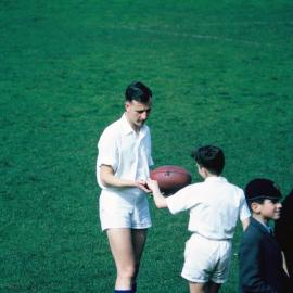 The umpire checks at the end of the game, 1965