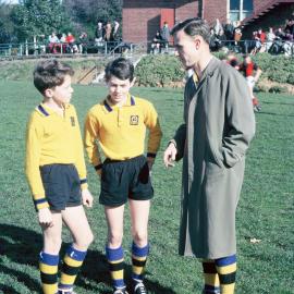 Captains confer with the coach, 1965 