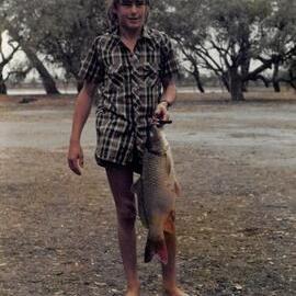 Greg Harding holding carp fish, 1978