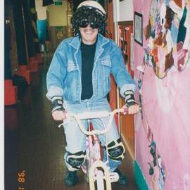 Gerry Riviere dressed up on bicycle, 1998