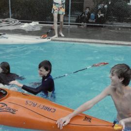 Practising rolling of canoe in Junior School pool, 1989