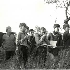 Students checking direction with compass and map, 1967