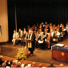 Ivan Poole addressing the audience at the  rededication of the Memorial Great Hall, 1995