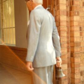 Arthur Locke holding original school bell during Founders Day celebrations 1983