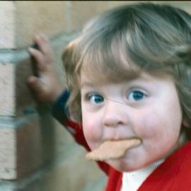 Unidentified toddler with biscuit, 1974